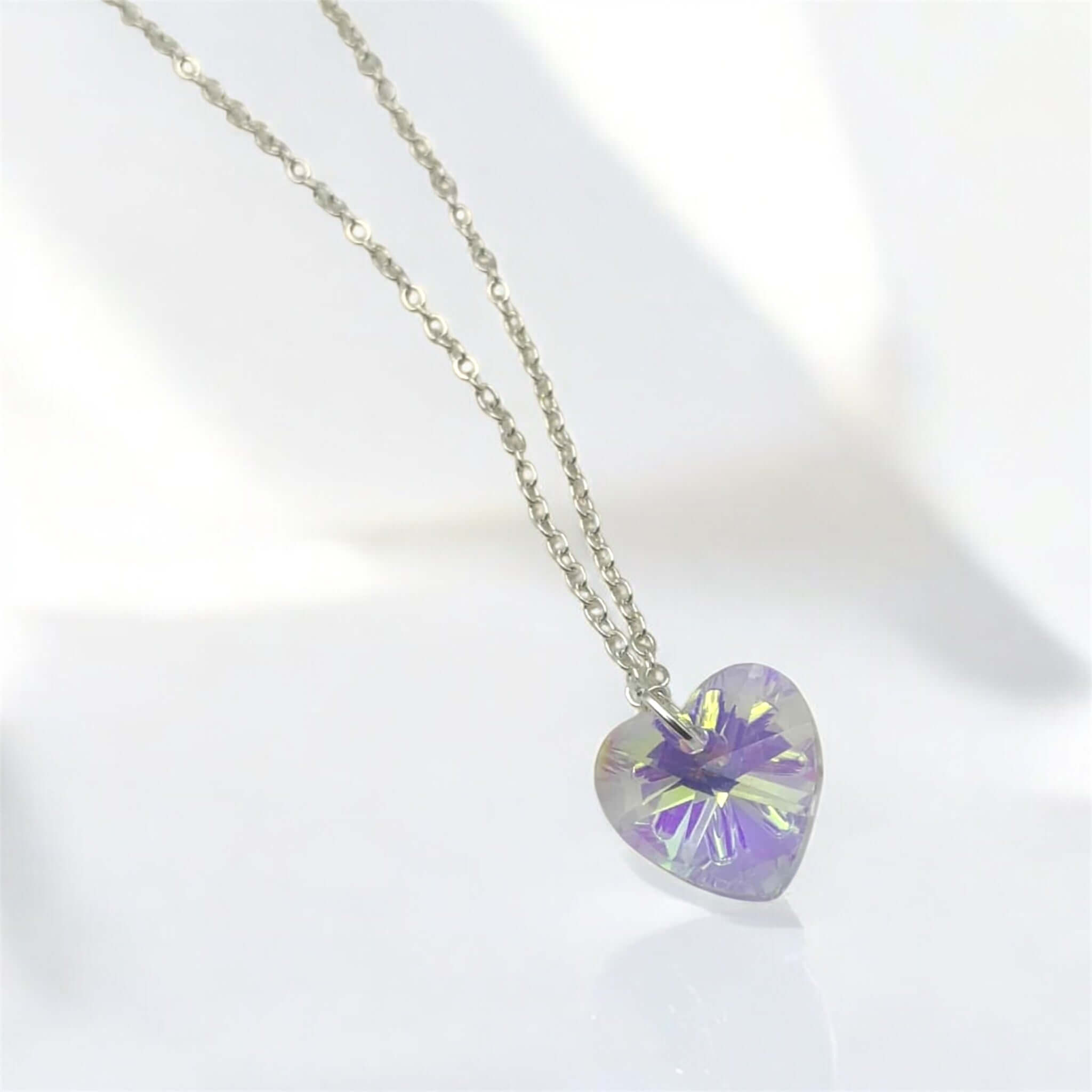 Heart-shaped purple pendant on a chain against a white background