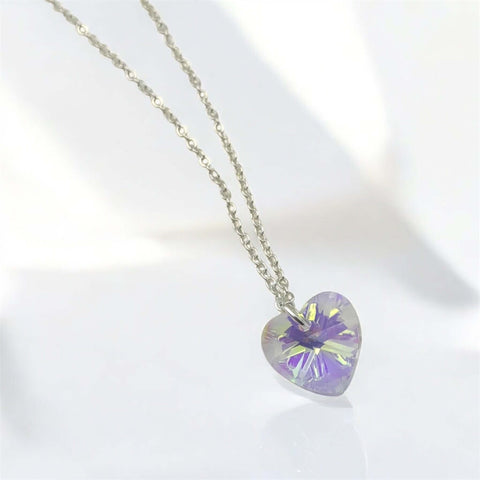 Heart-shaped purple pendant on a chain against a white background