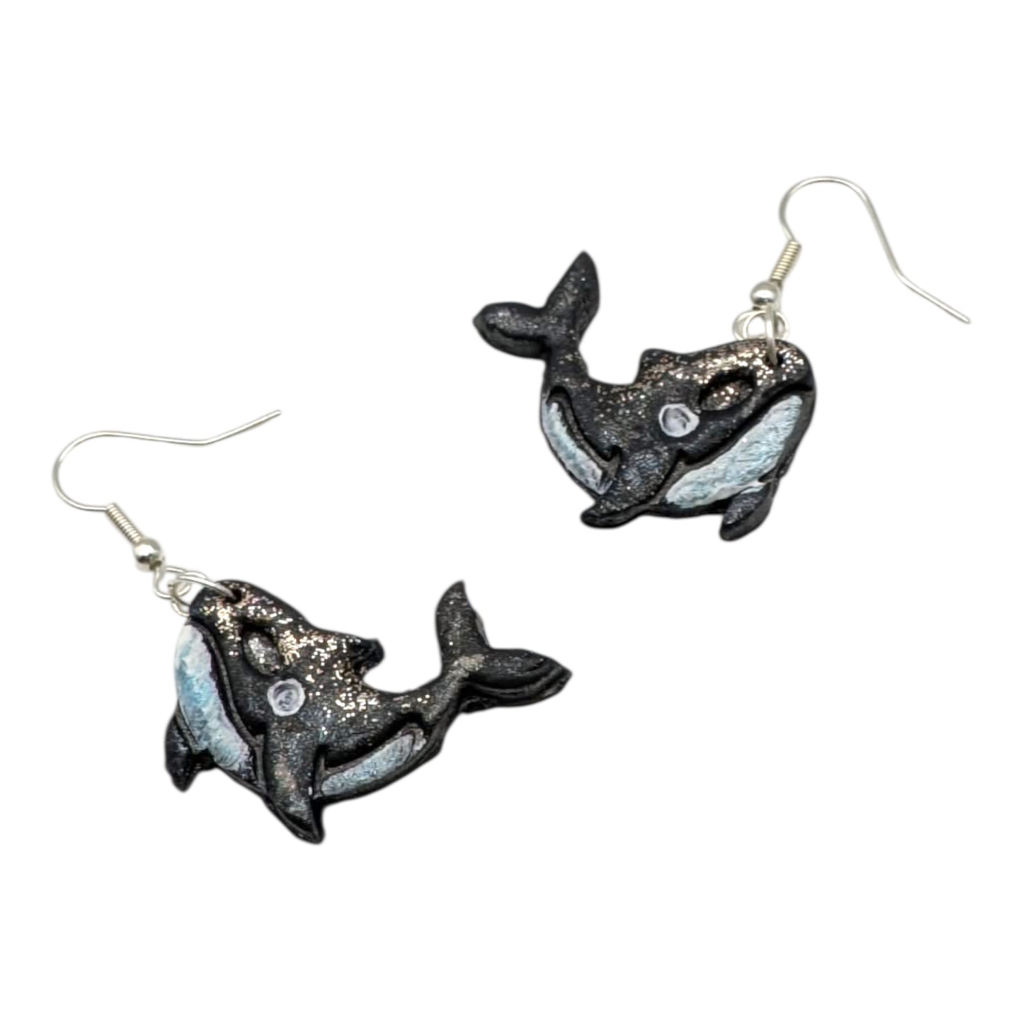 Whale-shaped earrings on a white background