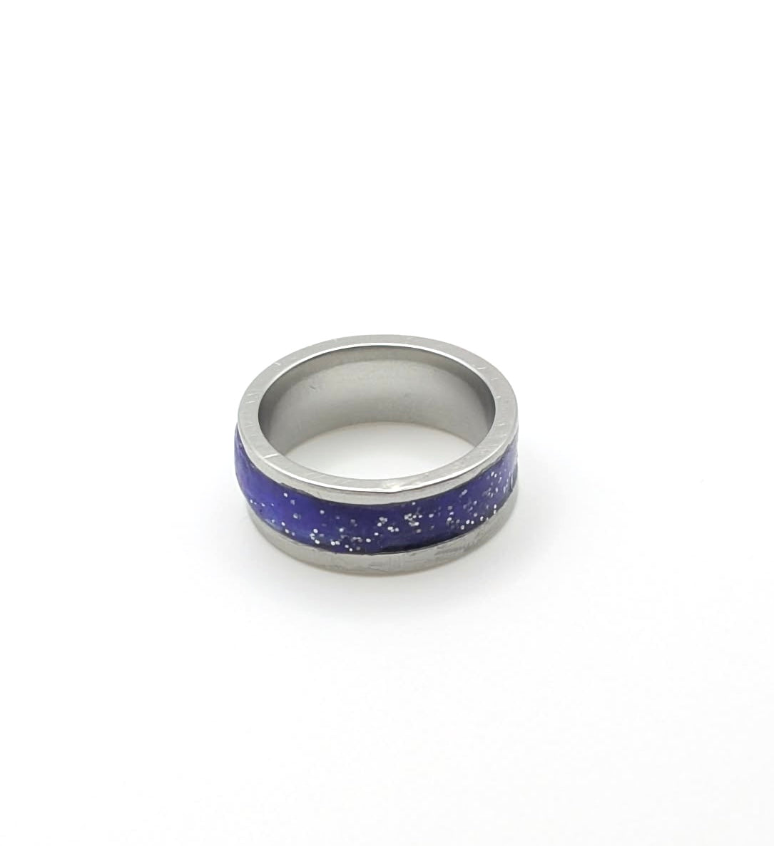 Silver ring with a blue speckled band on a white background