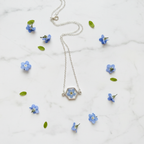 simple forget me not real flower In silver  shaped hexagon  pendant on a silver chain with lobster clasp closure. 