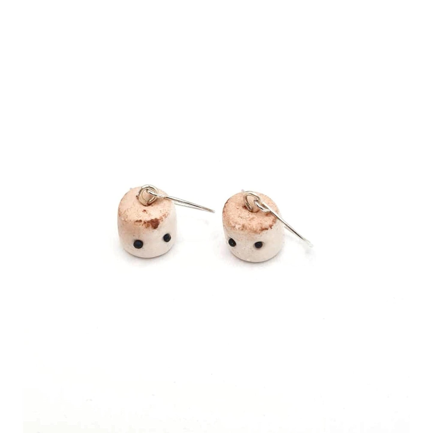 Pair of small round earrings with a textured surface on a white background