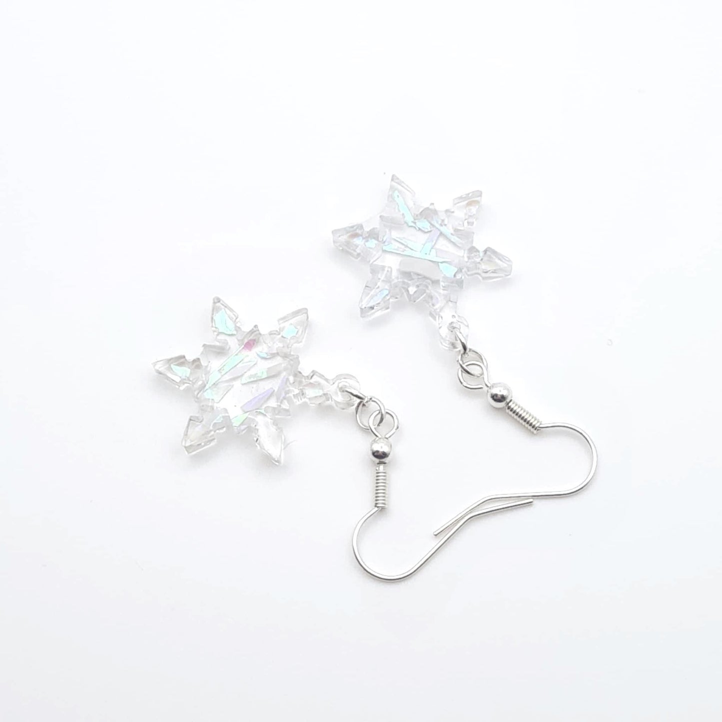 Star-shaped crystal earrings on a white background