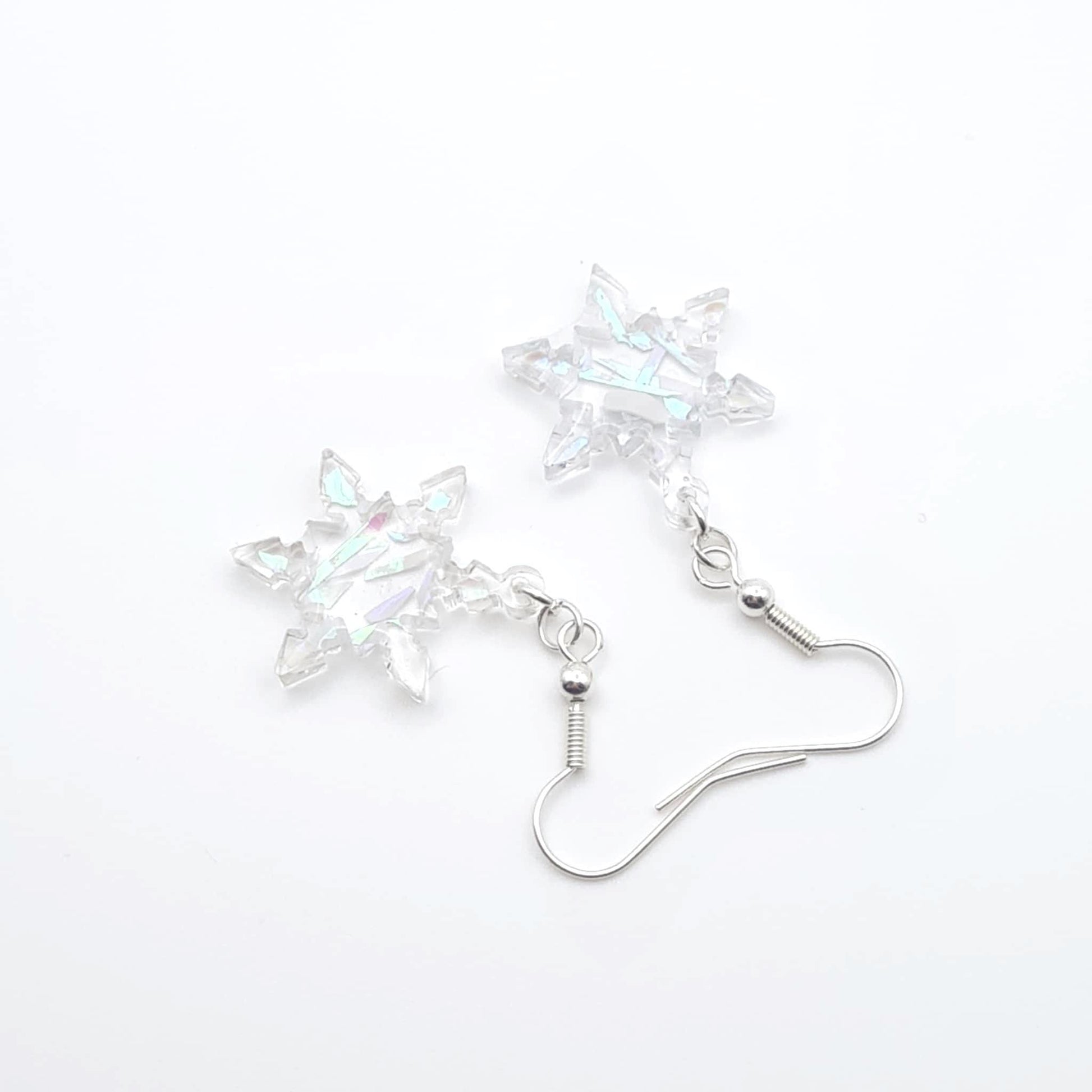 Star-shaped crystal earrings on a white background