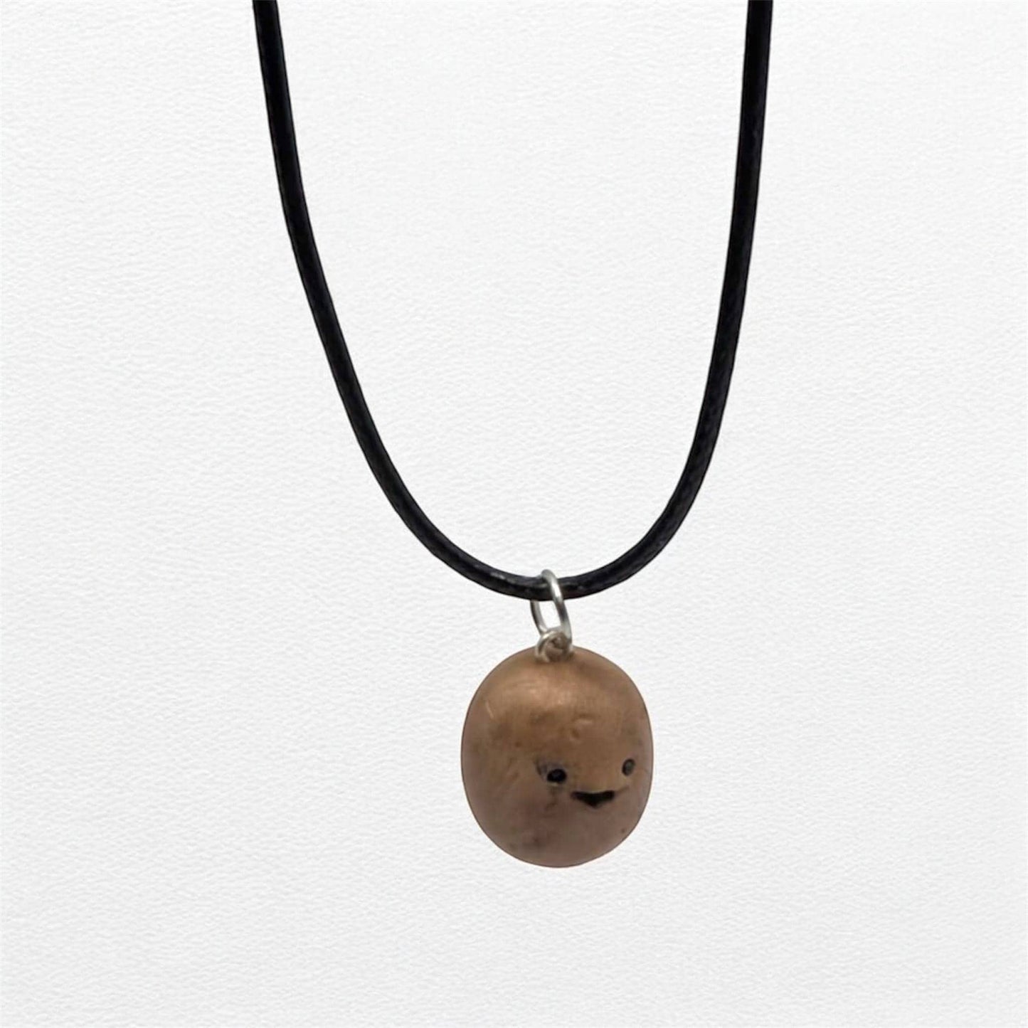 Necklace with a round tiny food pendant on a white background