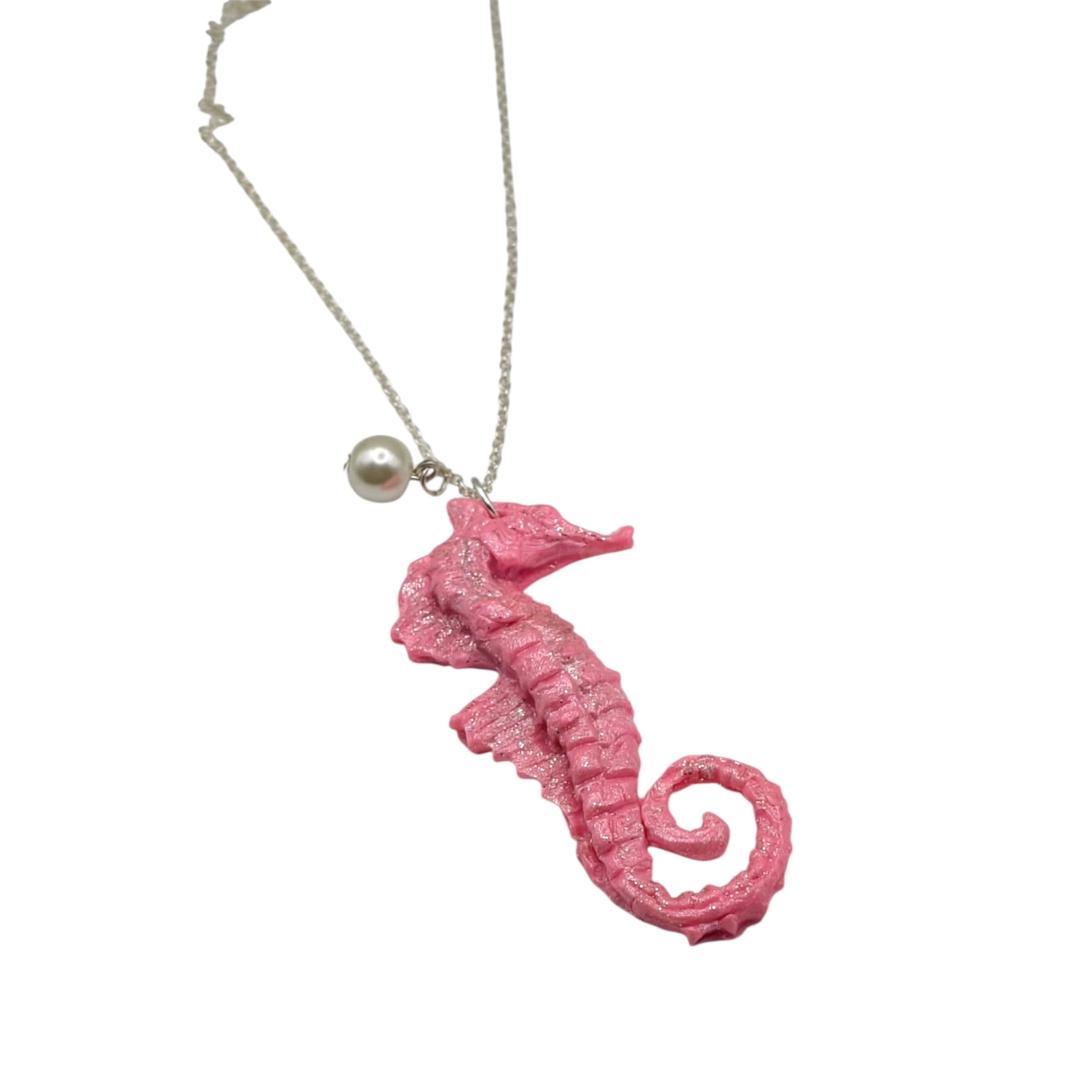 Pink seahorse necklace laid flat on white background showing full 18-inch chain and pendant detail
