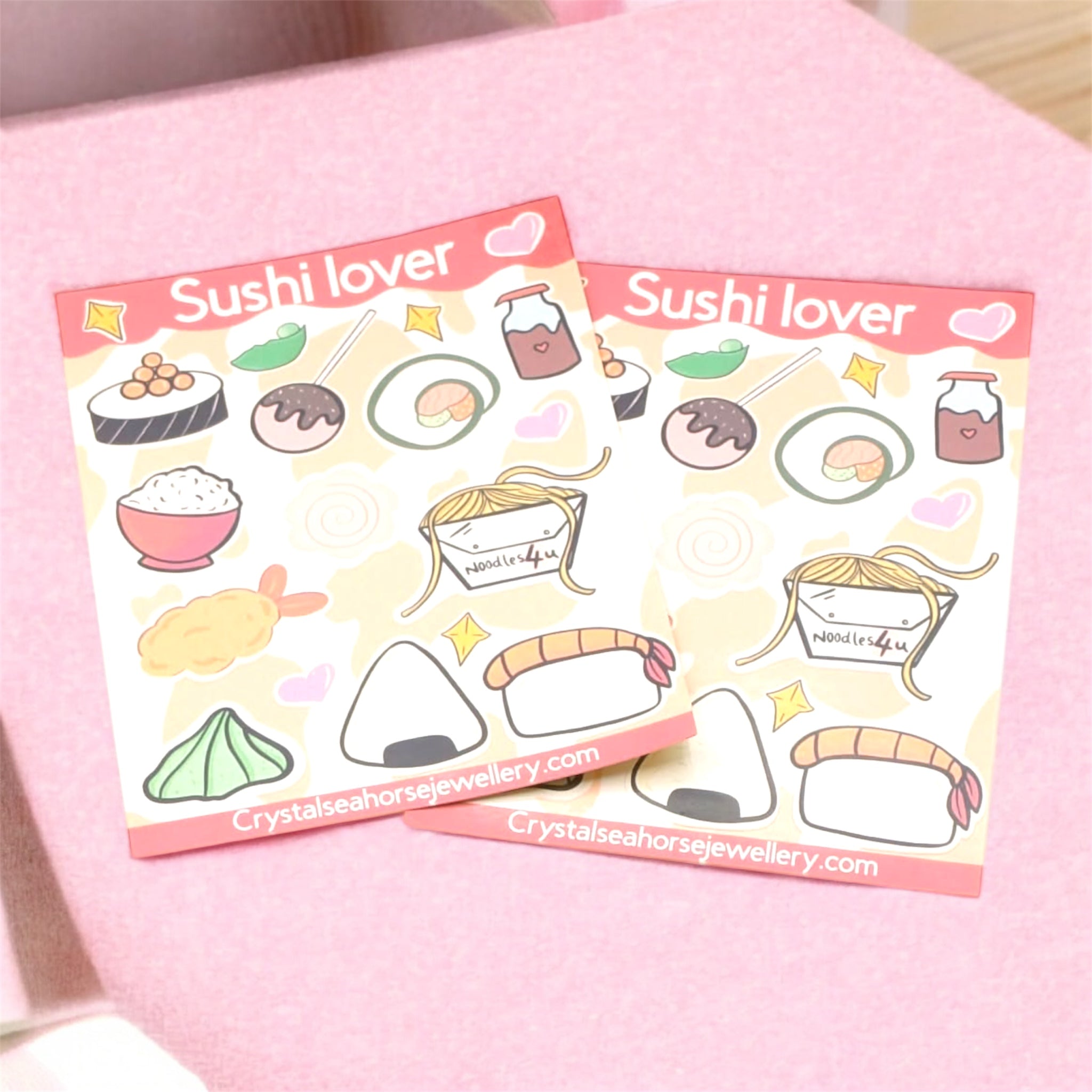 Two sheets of 'Sushi lover' stickers on a pink surface.