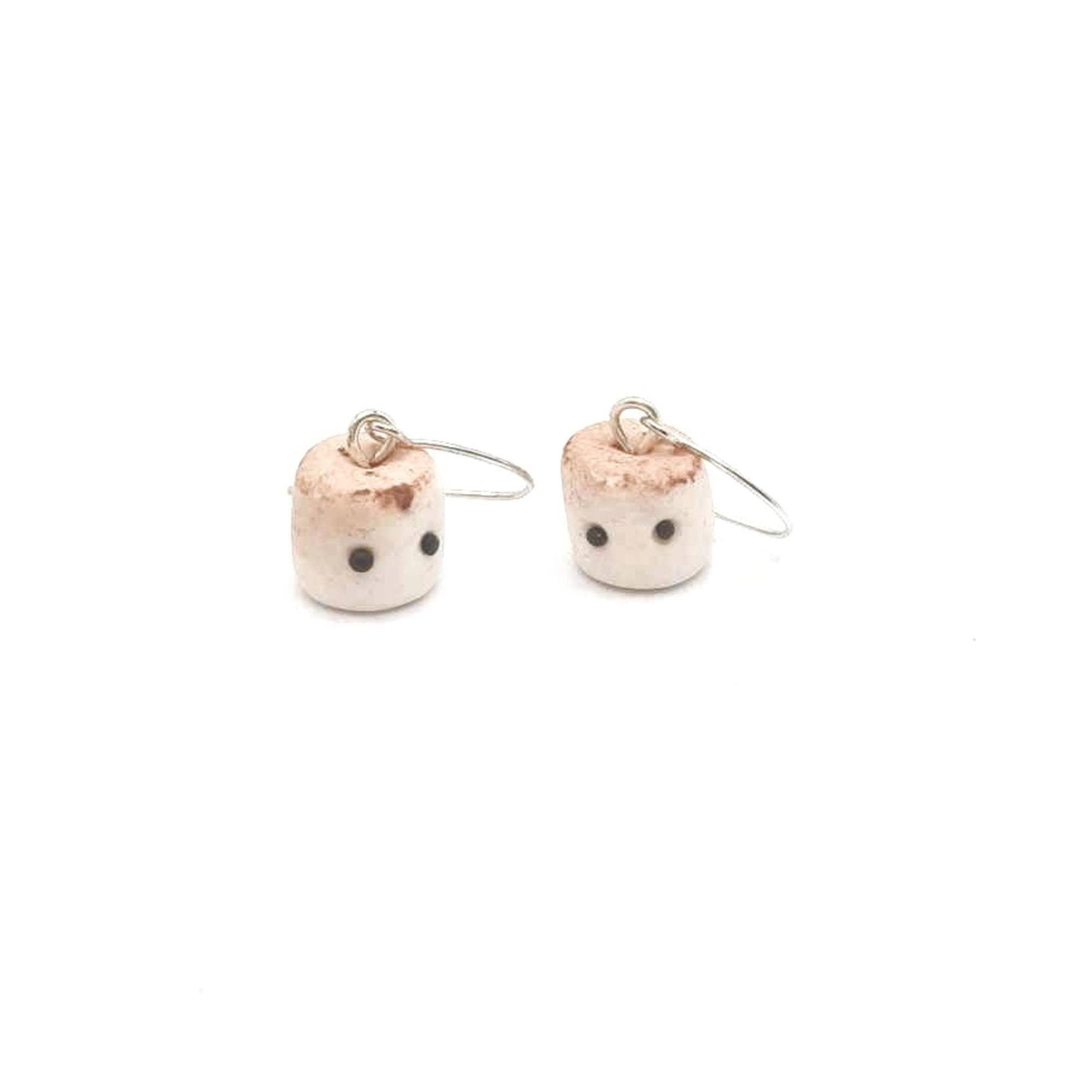Pair of earrings shaped like small marshmallow sweets with a white background