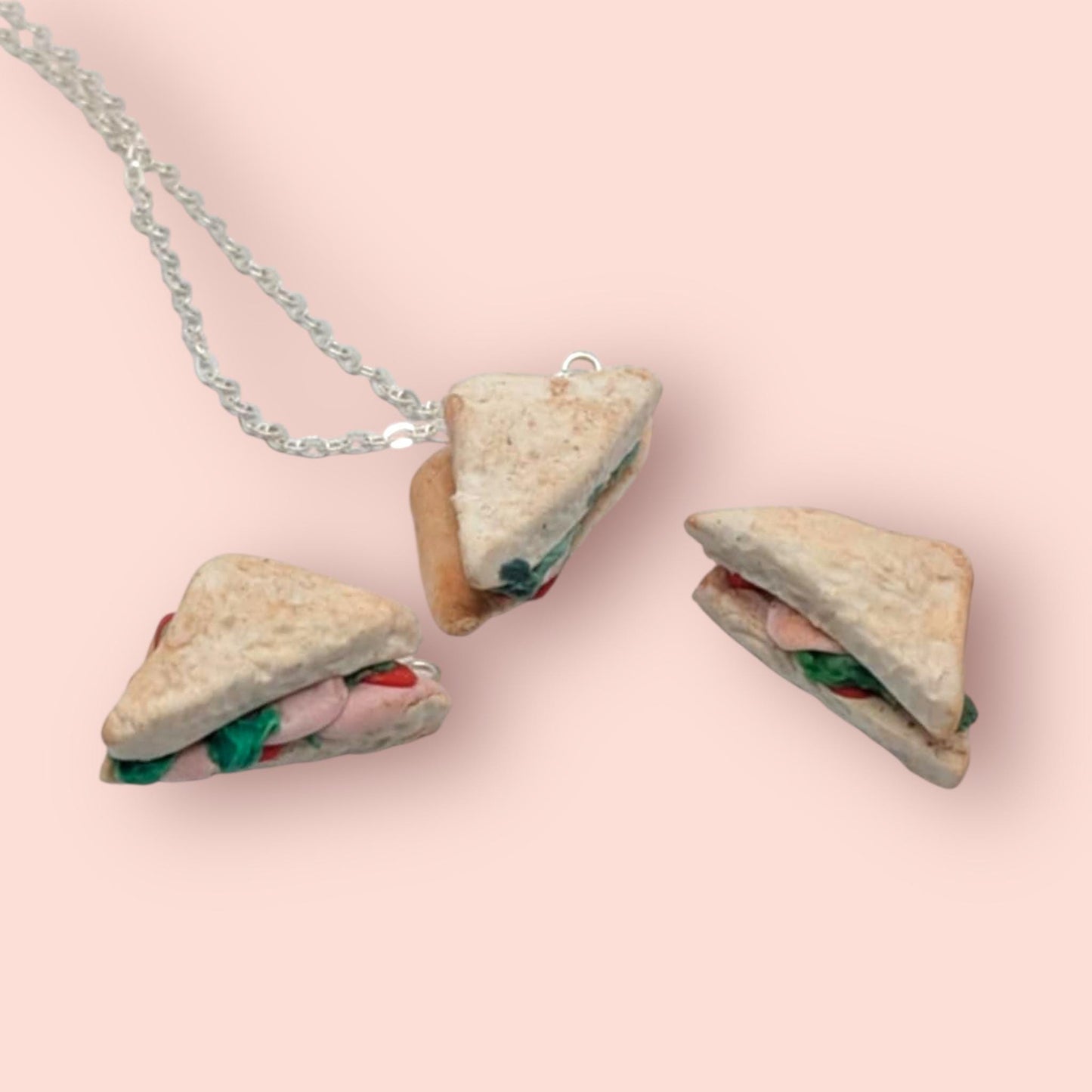 Sandwich-shaped pendant necklace on a pink background