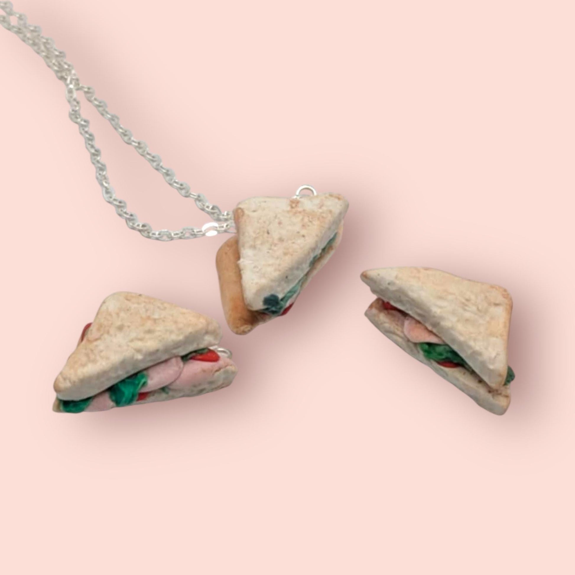 Sandwich-shaped pendant necklace on a pink background