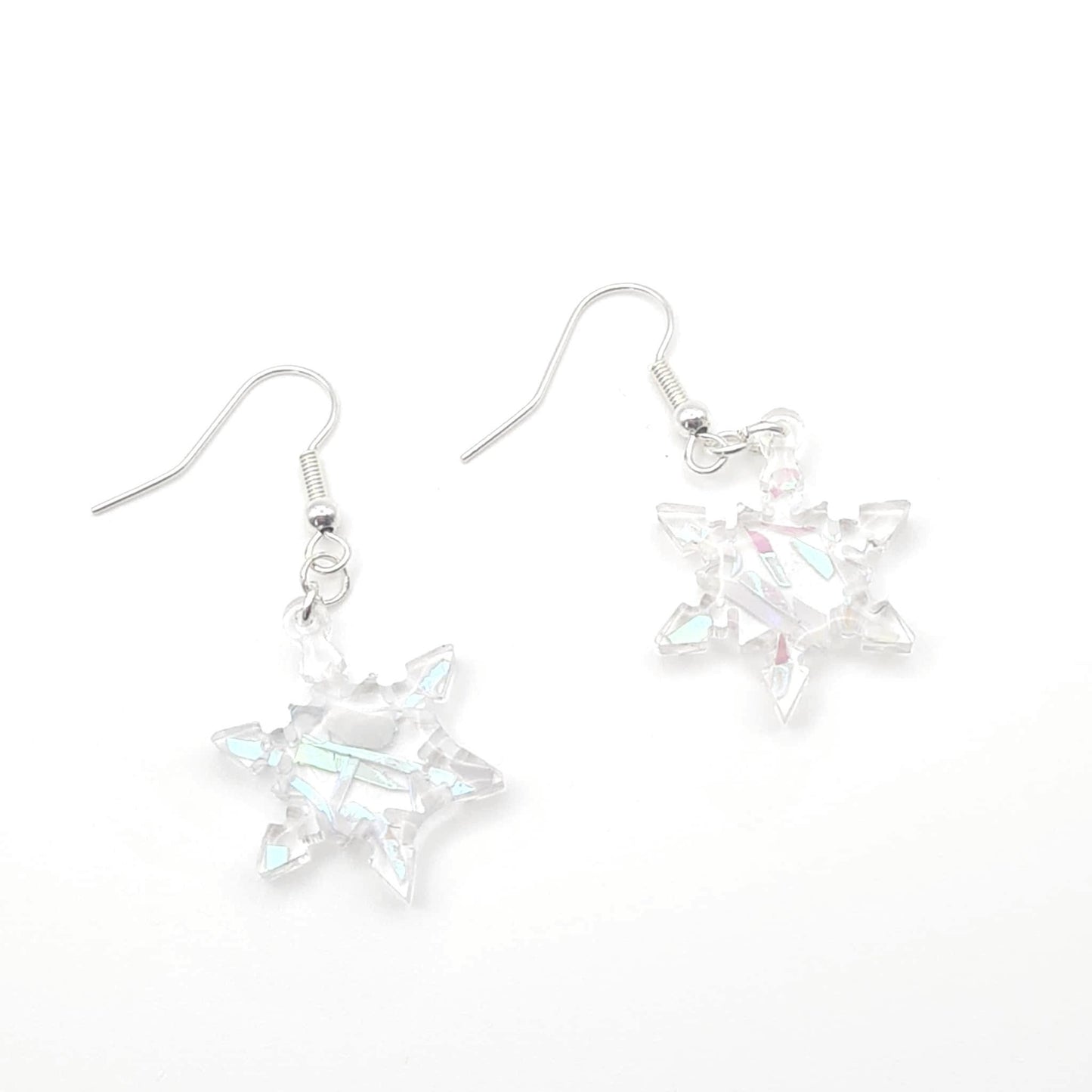 Star-shaped earrings with a metallic finish on a white background