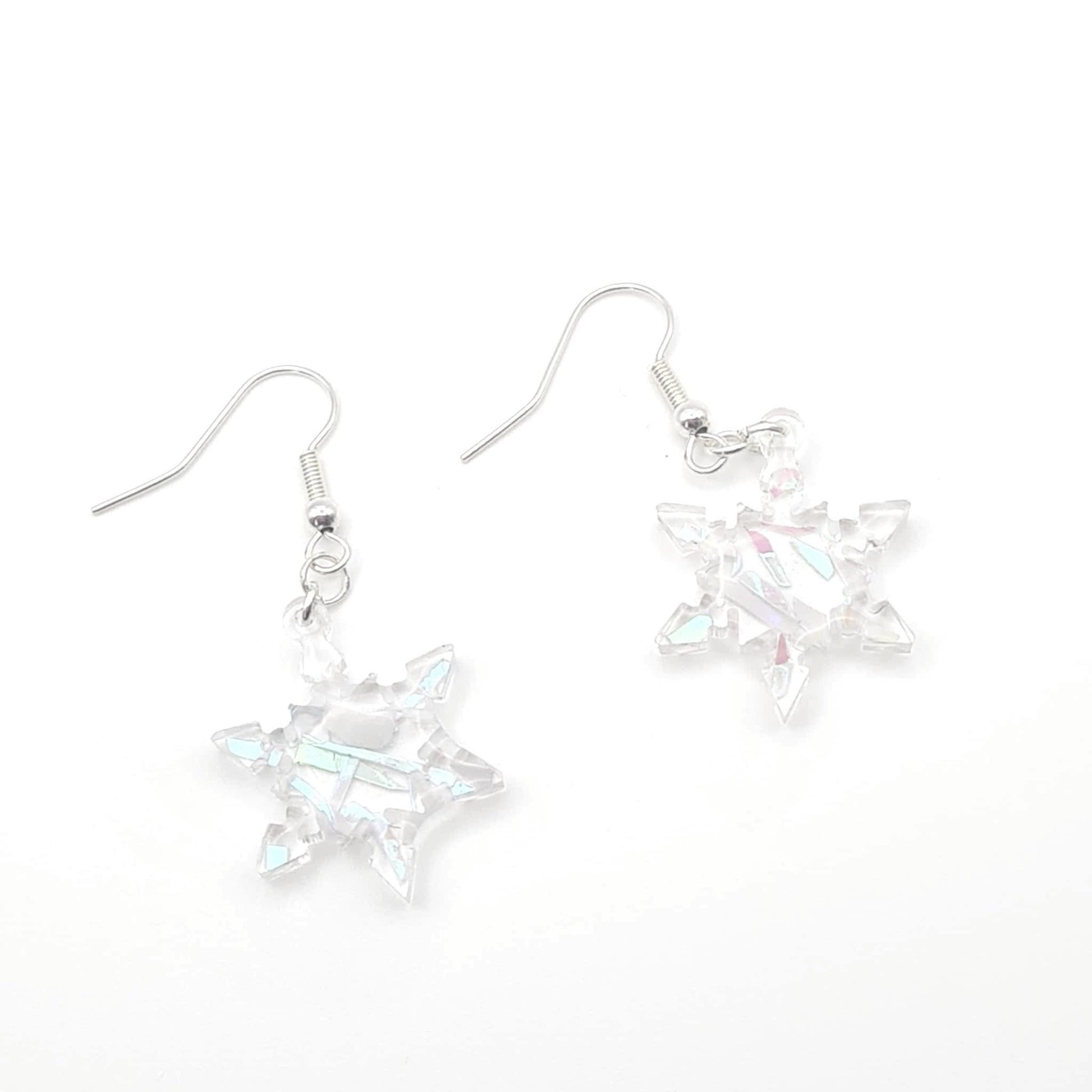 Star-shaped earrings with a metallic finish on a white background