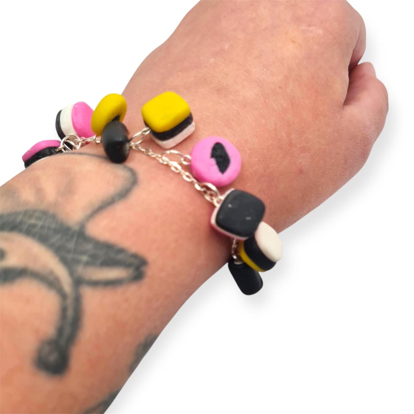 Colorful beaded bracelet on a wrist with a tattoo