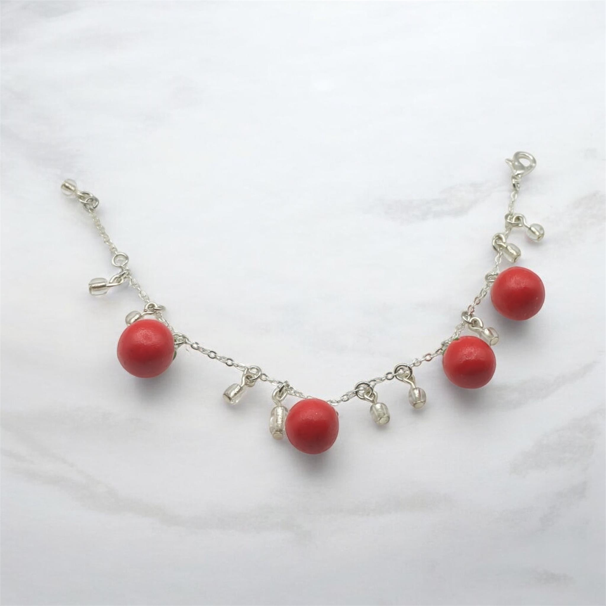 Bracelet with 4 red tomato’s on silver chain with crystal glass accents 