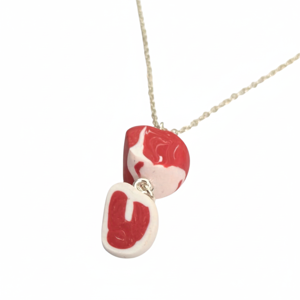 Close-up of red and white raw steak necklace
