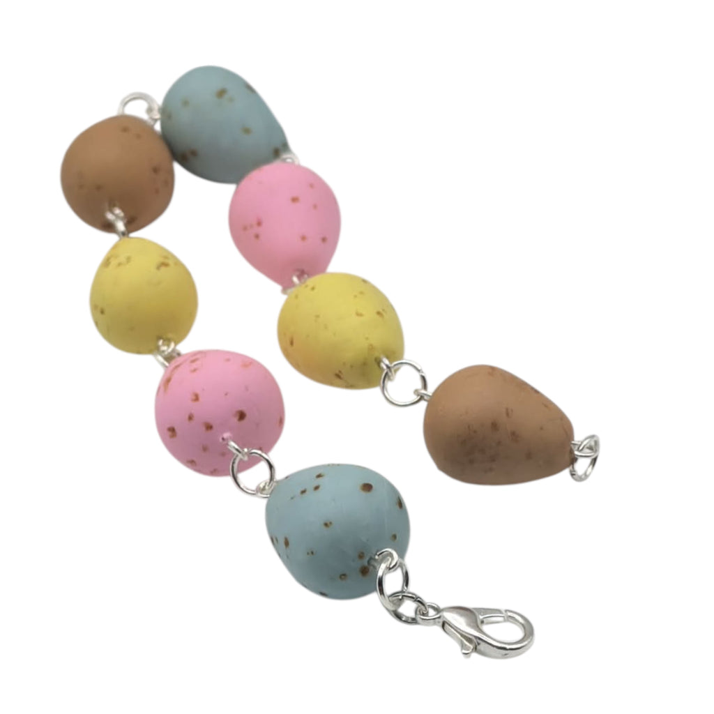 Colourful pastel mini egg bracelet on white background