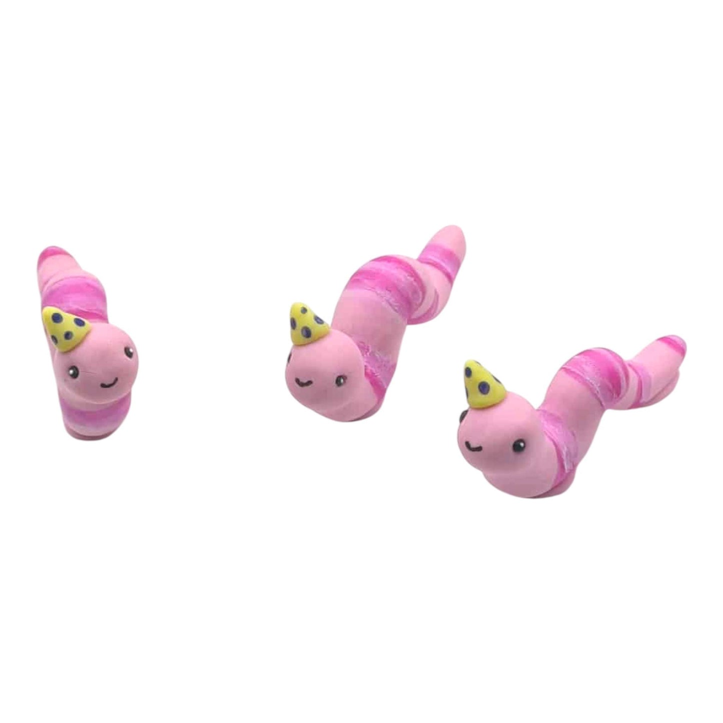Three pink worm shaped sculptures with yellow crowns on a white background